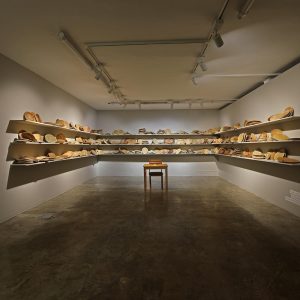 installation view/bread dough, wooden shelves, chair, desk,, sulfur