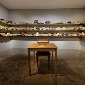 installation view/bread dough, wooden shelves, chair, desk,, sulfur